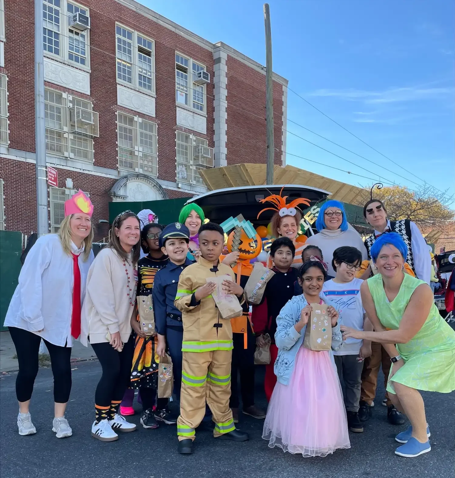 Students and teachers in Halloween costumes in the school yard