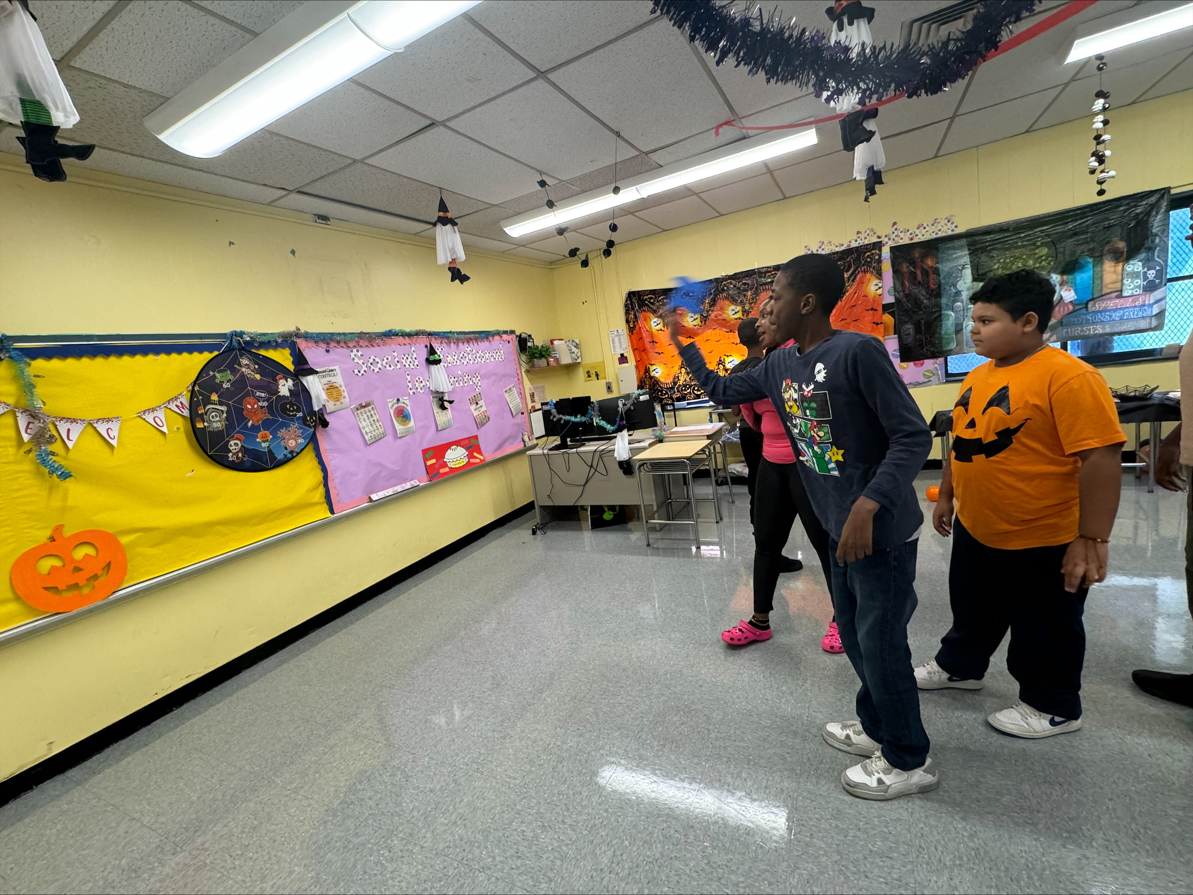 students playing a dart game