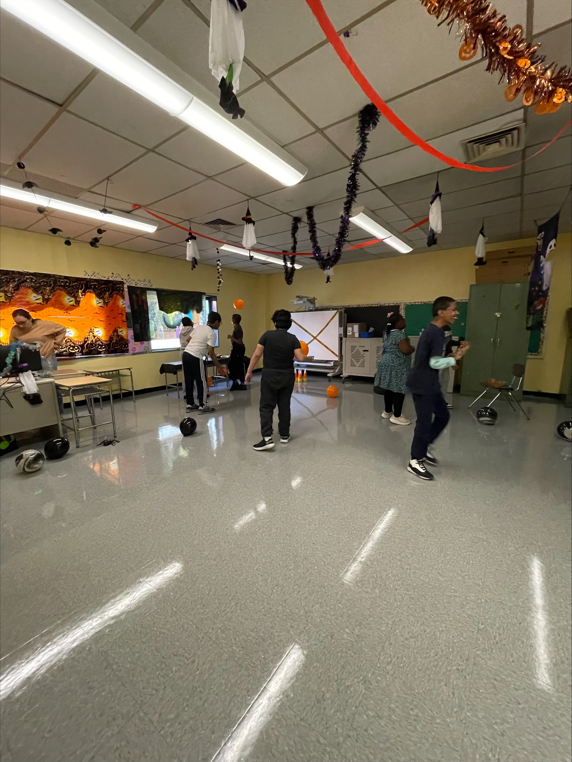 students playing with orange balloons