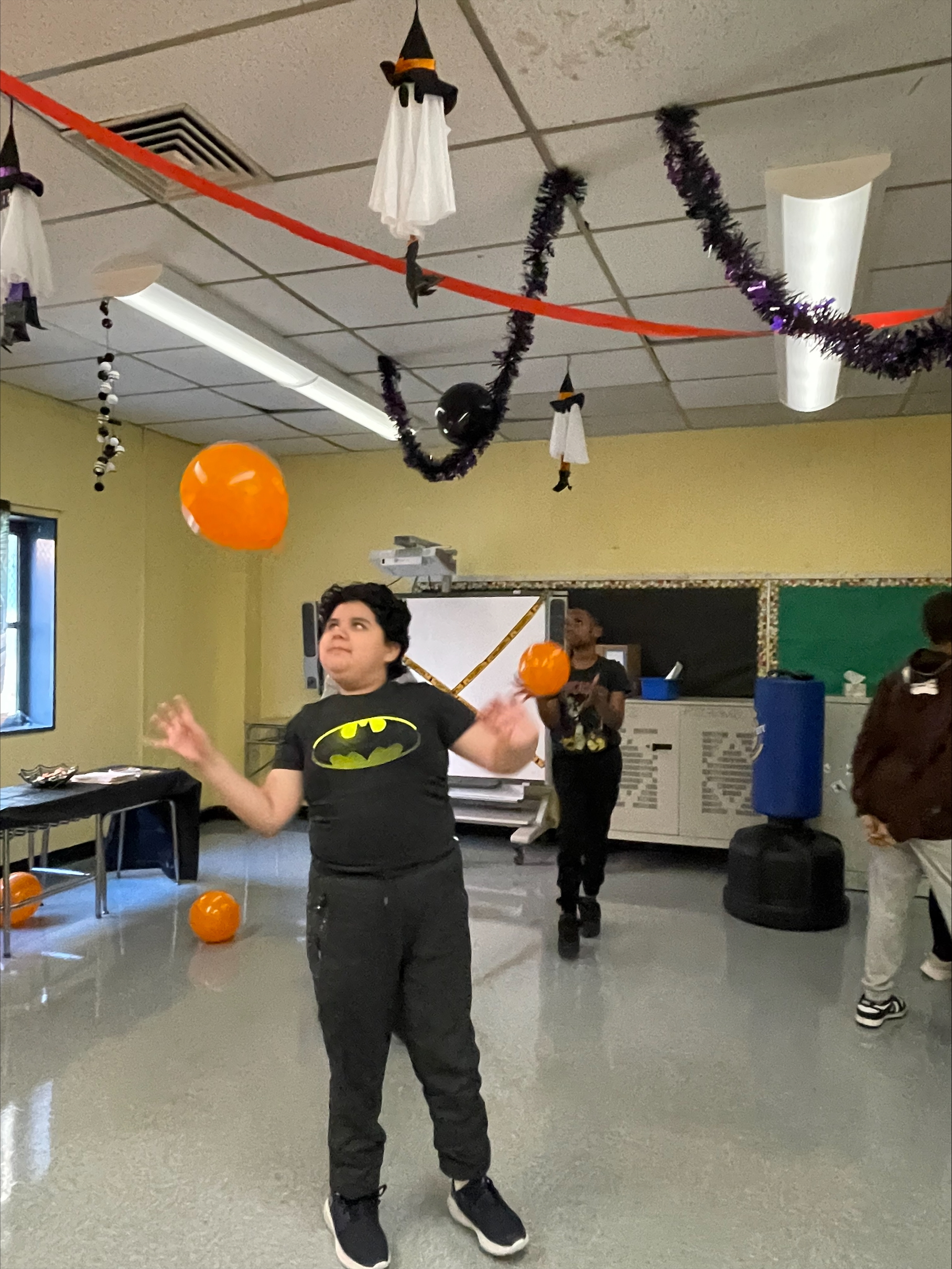 Student playing with an orange balloon