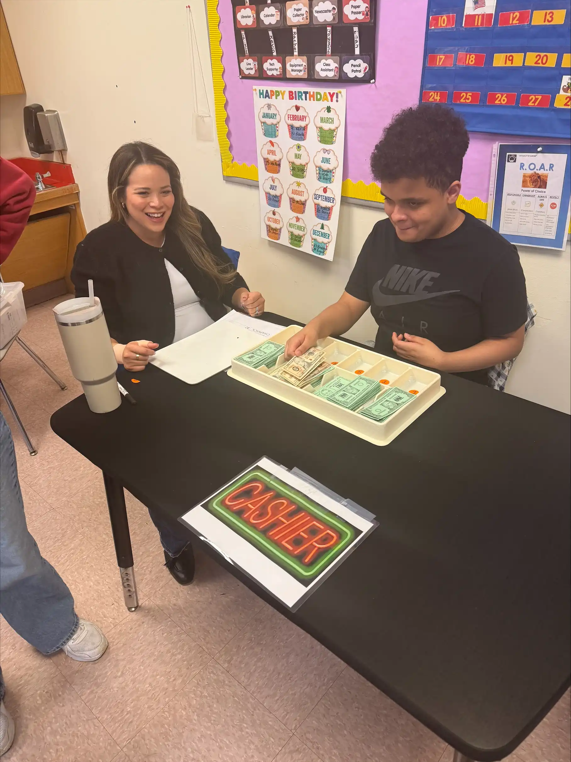 Student counting money as a class cashier