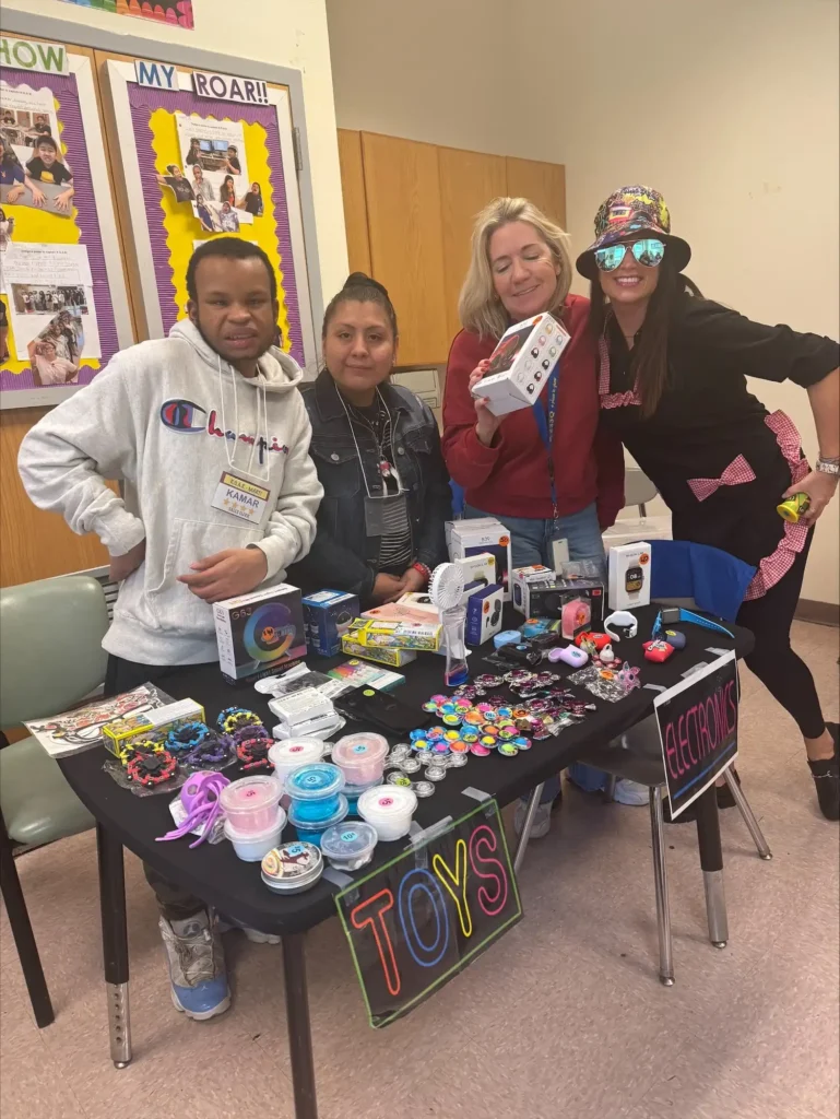 students and their 2 teachers in their classroom store